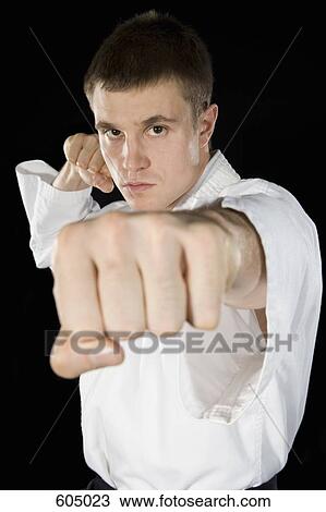 A young man practicing karate View Large Photo Image Stock Image - A young man practicing karate. Fotosearch