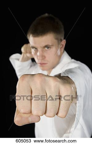 A young man practicing karate View Large Photo Image Stock Image - A young man practicing karate. Fotosearch