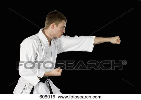 Stock Photograph - A young man practicing karate. Fotosearch