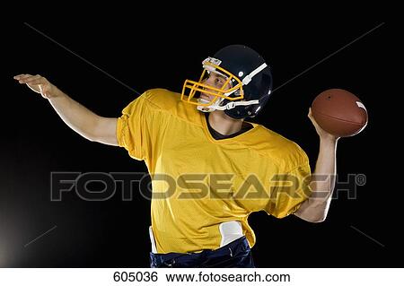 An American football player throwing a ball View Large Photo Image Stock Photograph - An American football player throwing a ball. Fotosearch