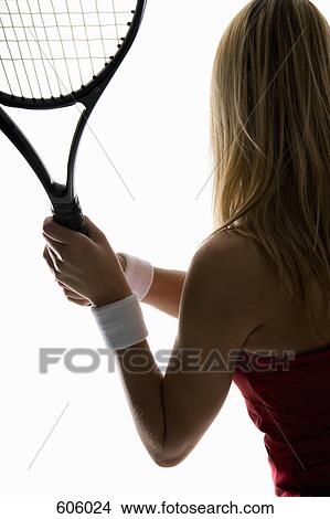 Picture - A close-up studio shot of a female tennis player holding a tennis racket. Fotosearch