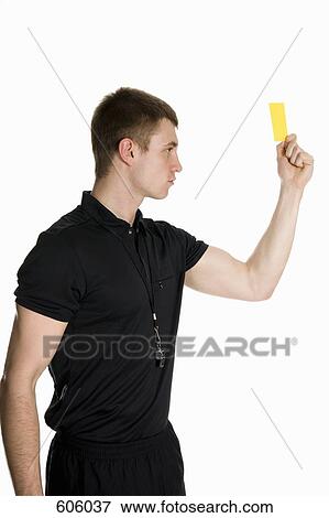 A referee holding up a yellow card View Large Photo Image Stock Photo - A referee holding up a yellow card. Fotosearch