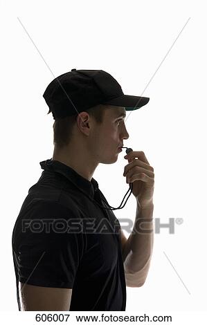 Side view studio portrait of a referee blowing a whistle View Large Photo Image Stock Photo - Side view studio portrait of a referee blowing a whistle. Fotosearch