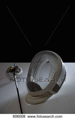 Still life Studio Shot of a fencing foil and a fencing mask View Large Photo Image Stock Photo - Still life Studio Shot of a fencing foil and a fencing mask. Fotosearch