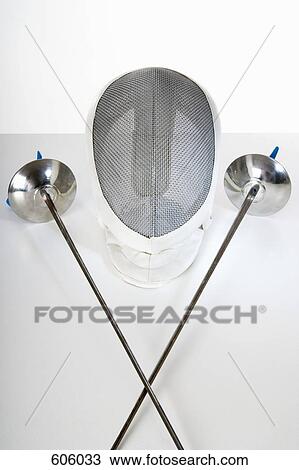 Stock Image - Still life Studio Shot of two fencing foils and a fencing mask. Fotosearch