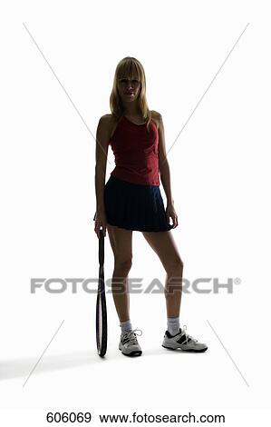 Studio portrait of a female tennis player holding a tennis racket View Large Photo Image Stock Photo - Studio portrait of a female tennis player holding a tennis racket. Fotosearch