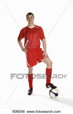 Studio portrait of soccer player with his foot on a soccer ball View Large Photo Image Stock Photograph - Studio portrait of soccer player with his foot on a soccer ball. Fotosearch