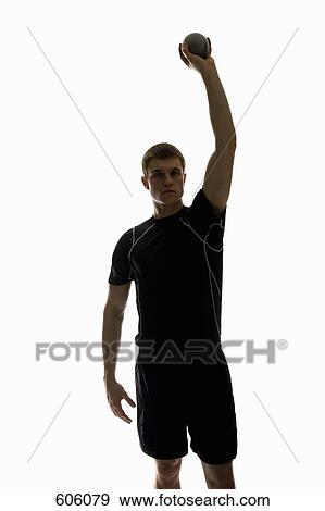 Stock Photo - Studio shot of a male track and field athlete holding a shot put ball. Fotosearch
