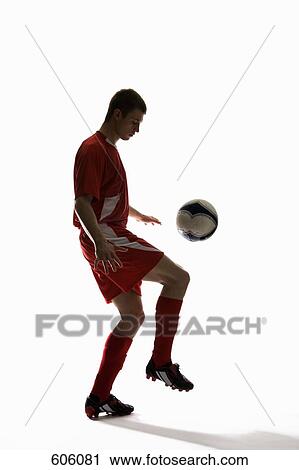 Studio shot of a soccer player bouncing a soccer ball on his knee View Large Photo Image Stock Image - Studio shot of a soccer player bouncing a soccer ball on his knee. Fotosearch
