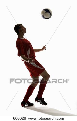 Studio shot of a soccer player bouncing a soccer ball on his chest View Large Photo Image Stock Photograph - Studio shot of a soccer player bouncing a soccer ball on his chest. Fotosearch