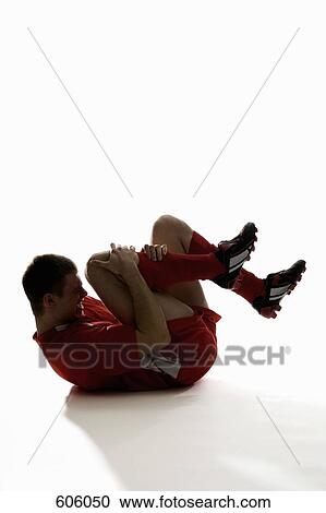 studio shot of an injured soccer player holding his leg in pain View Large Photo Image Stock Image - studio shot of an injured soccer player holding his leg in pain. Fotosearch
