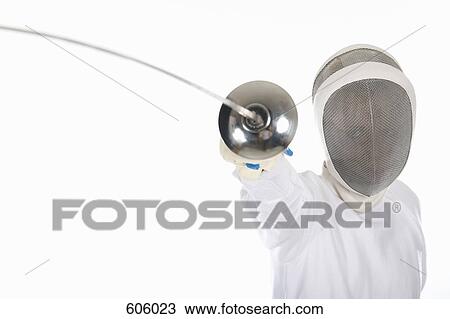 Stock Image - Studio shot of female fencer posing with a fencing foil. Fotosearch