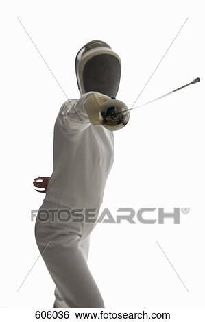 Studio shot of female fencer posing with a fencing foil View Large Photo Image Stock Photograph - Studio shot of female fencer posing with a fencing foil. Fotosearch