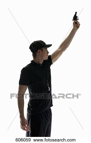 Stock Photo - Studio shot of referee holding a starting gun. Fotosearch