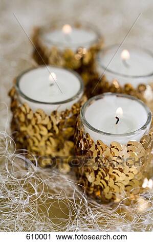 Stock Image - Four candles burning. Fotosearch
