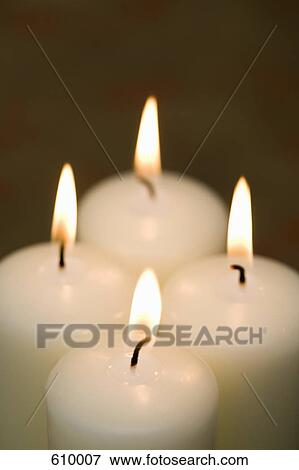 Stock Photo - Four candles burning. Fotosearch