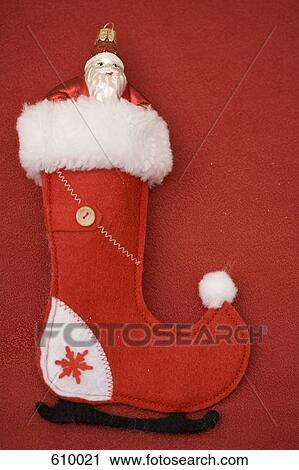 Stock Image - Santa Claus protruding from the top of a stocking. Fotosearch