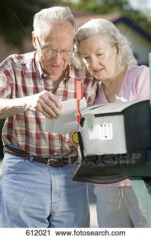 A senior couple checking the mailbox View Large Photo Image Stock Image - A senior couple checking the mailbox. Fotosearch