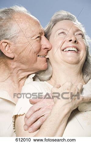 A senior couple embracing and laughing View Large Photo Image Stock Image - A senior couple embracing and laughing. Fotosearch