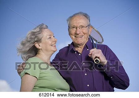 A senior couple with a tennis racket View Large Photo Image Picture - A senior couple with a tennis racket. Fotosearch