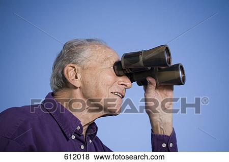 Stock Photo - A senior man using binoculars. Fotosearch