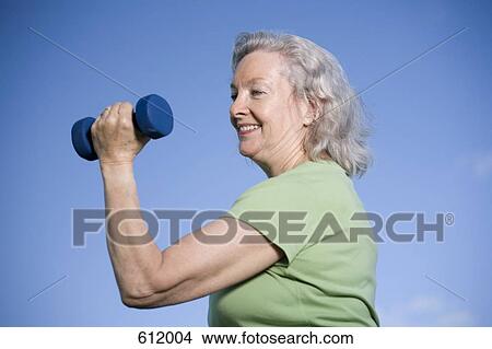 Picture - A senior woman doing exercise. Fotosearch