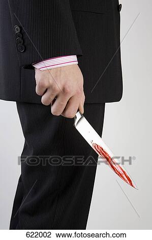 A businessman holding knife with blood on it View Large Photo Image Stock Image - A businessman holding knife with blood on it. Fotosearch