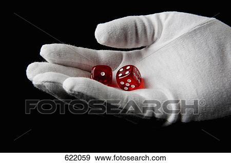 A gloved hand holding dice View Large Photo Image Stock Photo - A gloved hand holding dice. Fotosearch