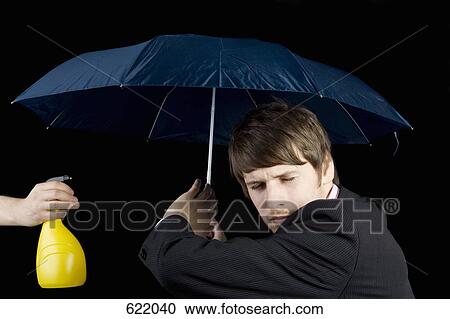 A man being squirted from a water bottle and holding an umbrella View Large Photo Image Stock Image - A man being squirted from a water bottle and holding an umbrella. Fotosearch