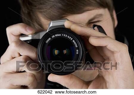 A man taking a photograph View Large Photo Image Stock Image - A man taking a photograph. Fotosearch