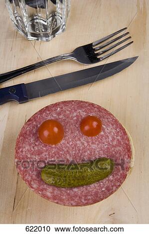 Stock Image - An anthropomorphic face on a slice of salami. Fotosearch