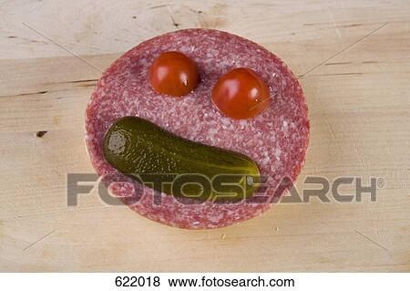 An anthropomorphic face on a slice of salami View Large Photo Image Stock Photo - An anthropomorphic face on a slice of salami. Fotosearch