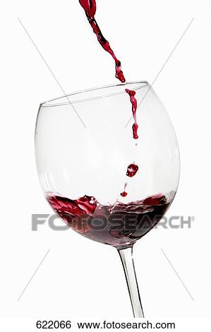 Red wine pouring into a glass View Large Photo Image Stock Photograph - Red wine pouring into a glass. Fotosearch
