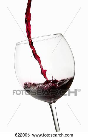 Stock Photography - Red wine pouring into a glass. Fotosearch