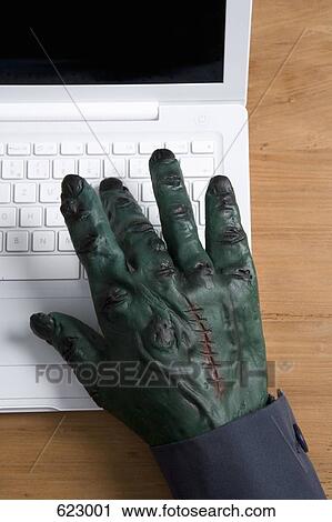 A monster's hand using a laptop View Large Photo Image Stock Image - A monster's hand using a laptop. Fotosearch