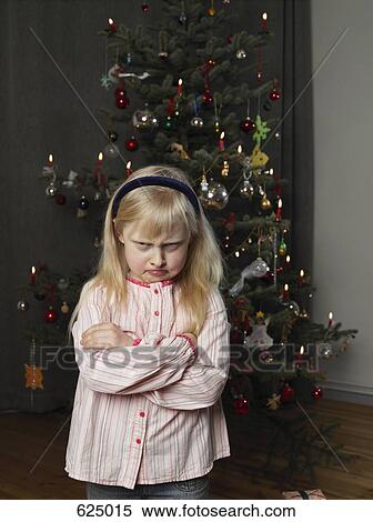 A girl sulking in front of a Christmas tree View Large Photo Image Stock Photography - A girl sulking in front of a Christmas tree. Fotosearch