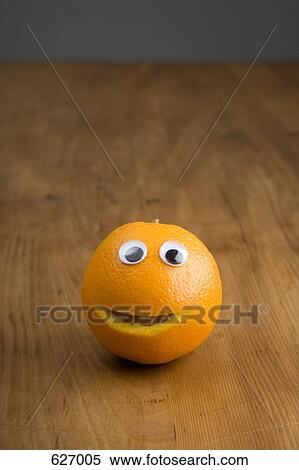 Stock Photography - A smiley face on an orange. Fotosearch