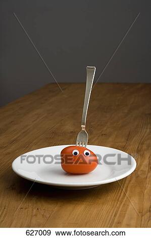 A tomato with plastic eyeballs and fork View Large Photo Image Stock Photo - A tomato with plastic eyeballs and fork. Fotosearch