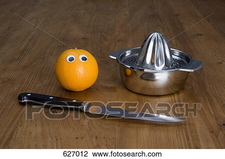 An orange, a juicer and a kitchen knife View Large Photo Image Stock Image - An orange, a juicer and a kitchen knife. Fotosearch
