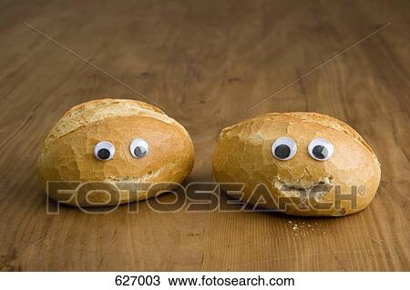 Stock Image - Two bread buns with anthropomorphic faces. Fotosearch