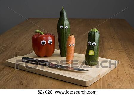Stock Image - Vegetables on a table with anthropomorphic faces. Fotosearch