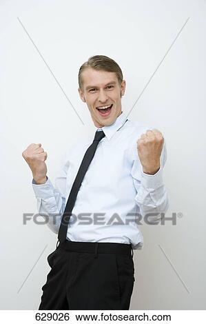A businessman clenching fist in happiness View Large Photo Image Stock Photograph - A businessman clenching fist in happiness. Fotosearch