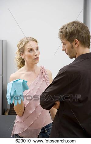 Stock Image - A couple arguing over domestic chores. Fotosearch