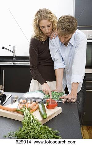 A couple preparing to cook in the kitchen View Large Photo Image Picture - A couple preparing to cook in the kitchen. Fotosearch