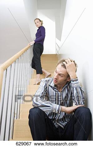 A mid adult couple arguing on a staircase View Large Photo Image Stock Photo - A mid adult couple arguing on a staircase. Fotosearch