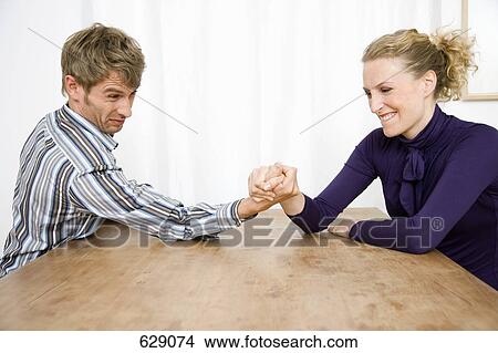 A mid adult couple arm wrestling View Large Photo Image Picture - A mid adult couple arm wrestling. Fotosearch