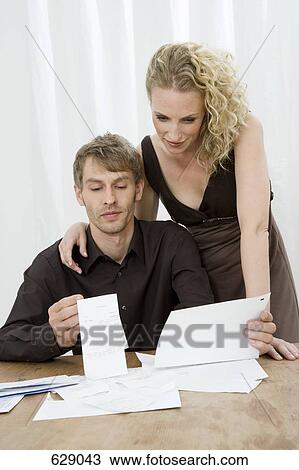 Stock Image - A mid adult couple doing home finances. Fotosearch