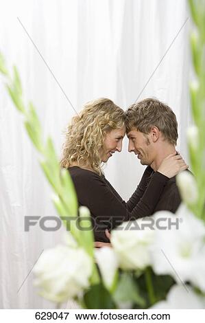 A mid adult couple embracing View Large Photo Image Stock Photo - A mid adult couple embracing. Fotosearch