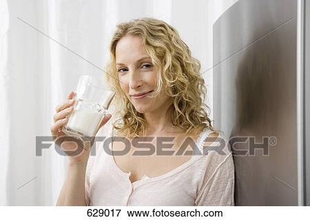 A woman drinking a glass of milk View Large Photo Image Stock Photo - A woman drinking a glass of milk. Fotosearch