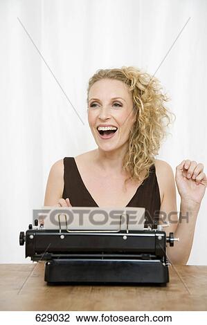 A woman using a typewriter View Large Photo Image Stock Image - A woman using a typewriter. Fotosearch
